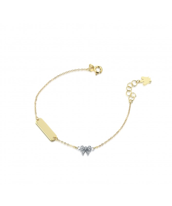 BRACCIALE CON TARGHETTA E ANGELO CHARM IN ORO GIALLO, FIOCCO IN ORO BIANCO CON ZIRCONI BIANCHI